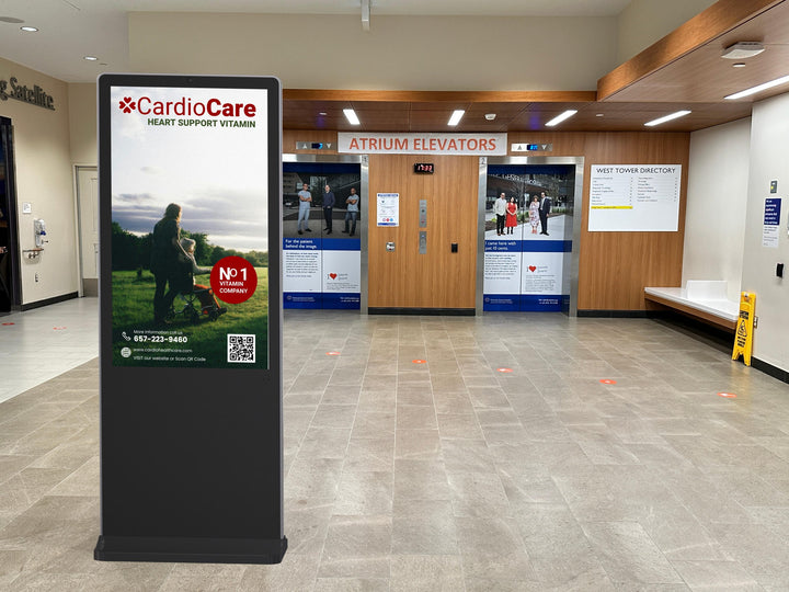 Indoor floor-standing kiosk in a hospital setting for patient check-in and information display